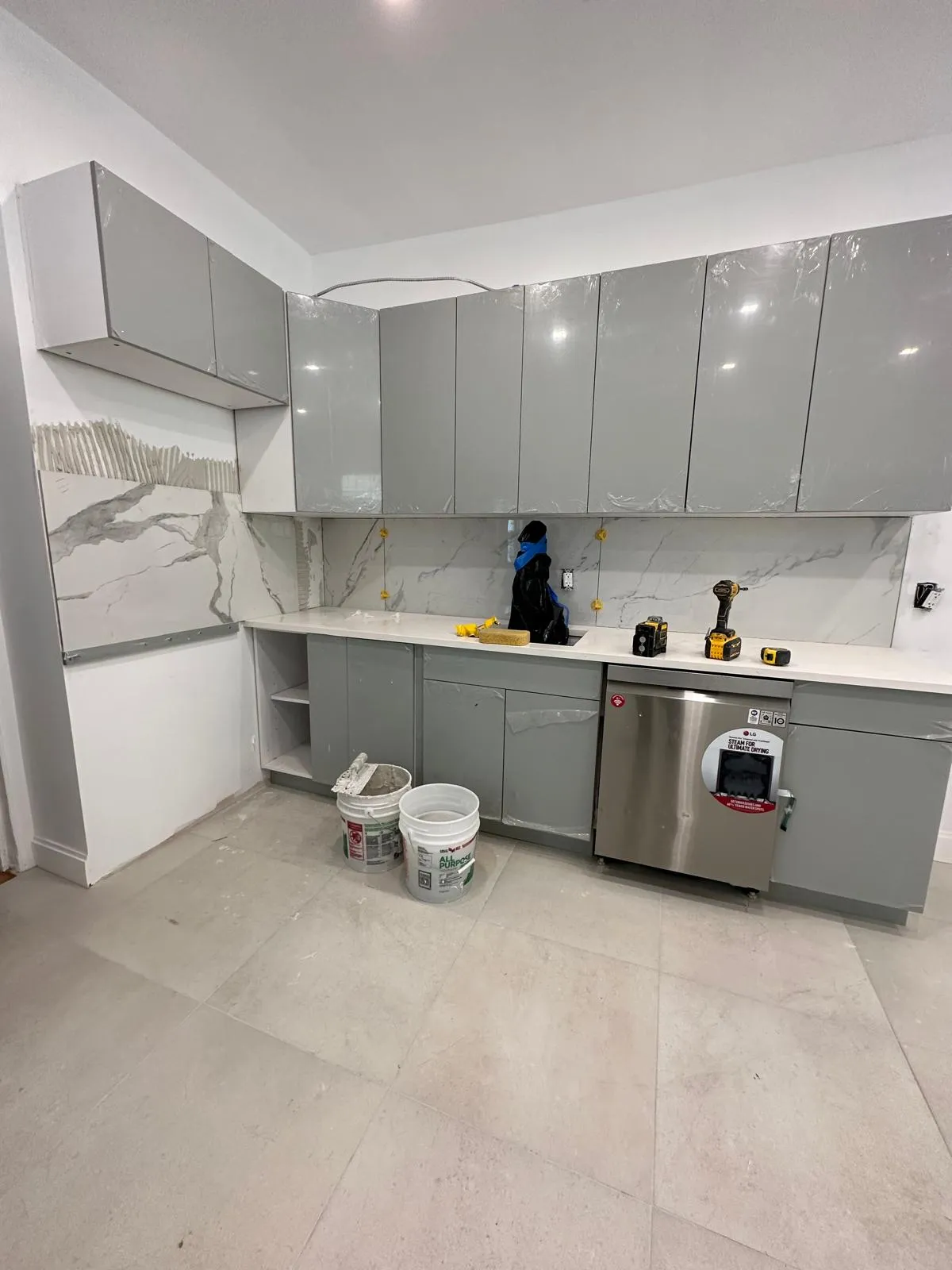 Cabinets being set and shimmed level in New Hampshire, New Generation General Construction