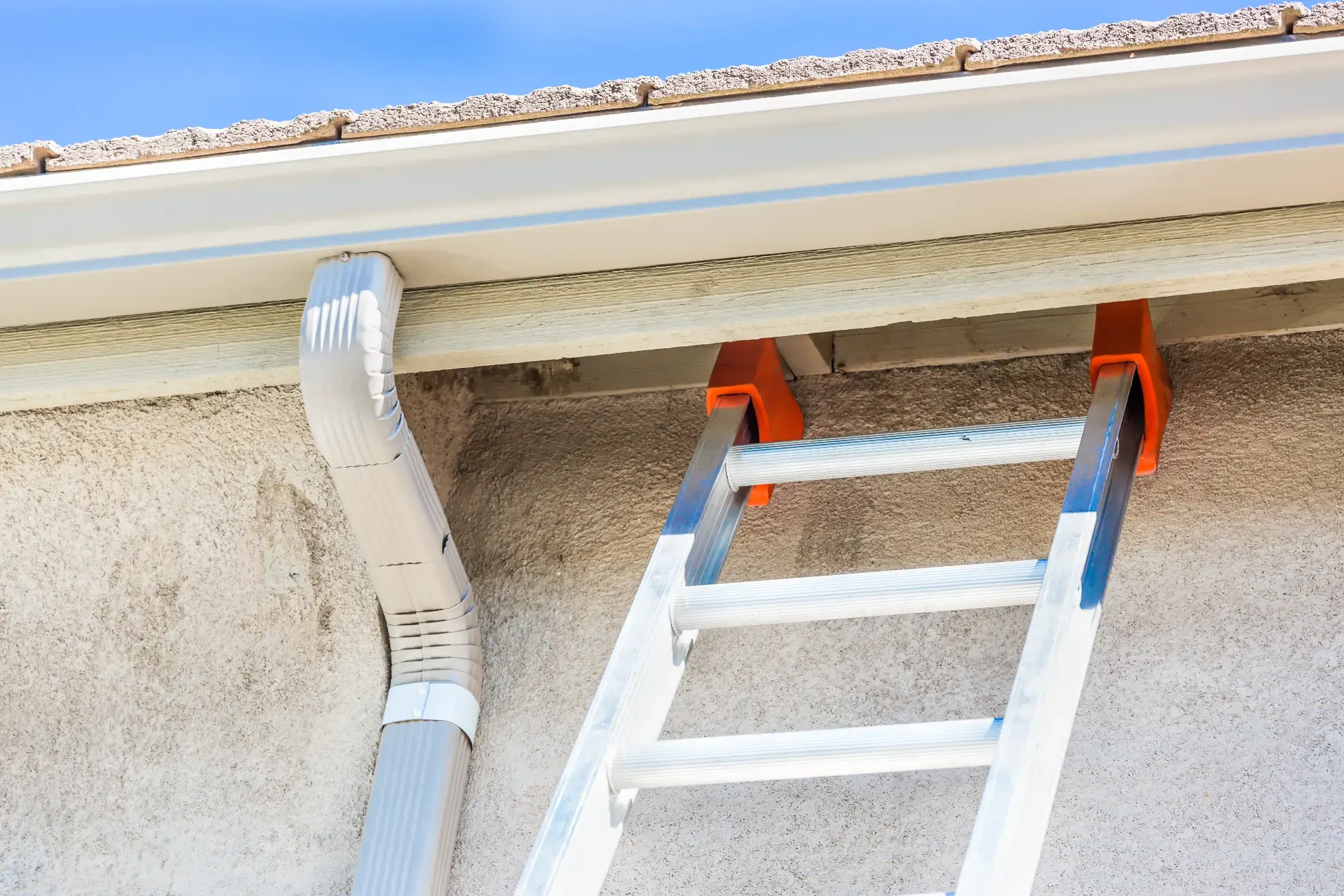 Seamless gutter installation in New Hampshire on a home roofline