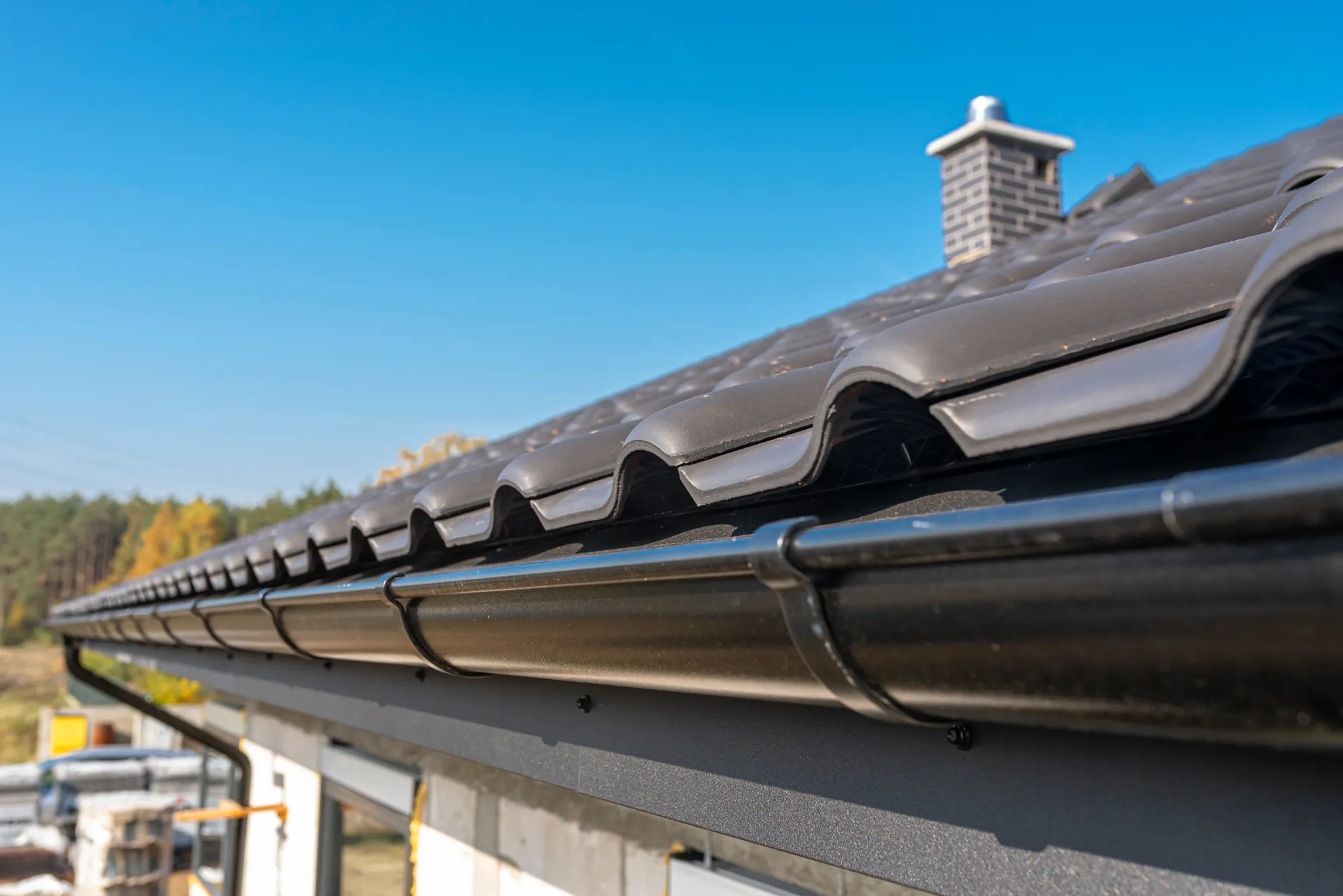 Seamless gutter run formed on site in New Hampshire, New Generation General Construction